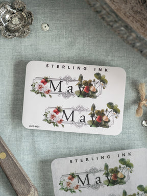 Elegant "Sterling Ink" seasonal stationery featuring a vintage wreath design of watercolor pink and white roses and greenery, perfect for June crafts or decorations.