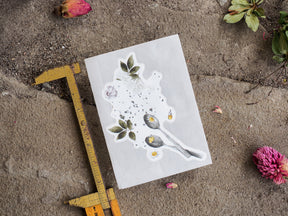Botanical die-cut sticker sheet displaying a delicate arrangement of mixed floral elements, green leaves, and scattered natural botanical designs.