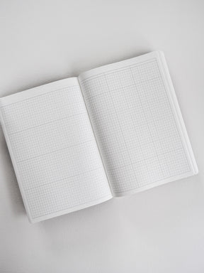 Open A5 common planner open to two pages of light-colored grid paper, designed for comprehensive and organized note-taking.