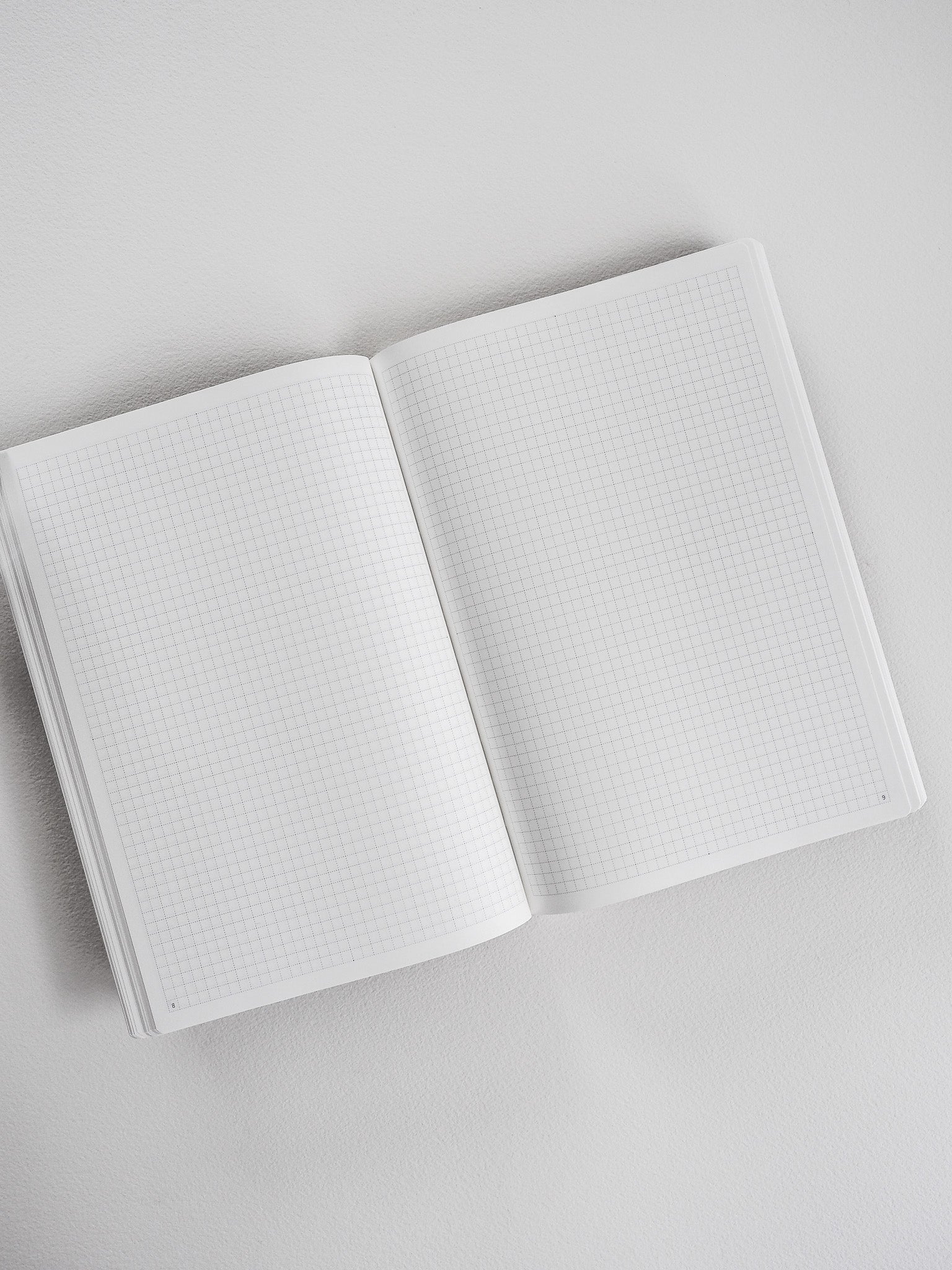 Open A5 graph paper planner revealing crisp, organized grid lines ideal for undated note-taking, journaling, and scheduling.