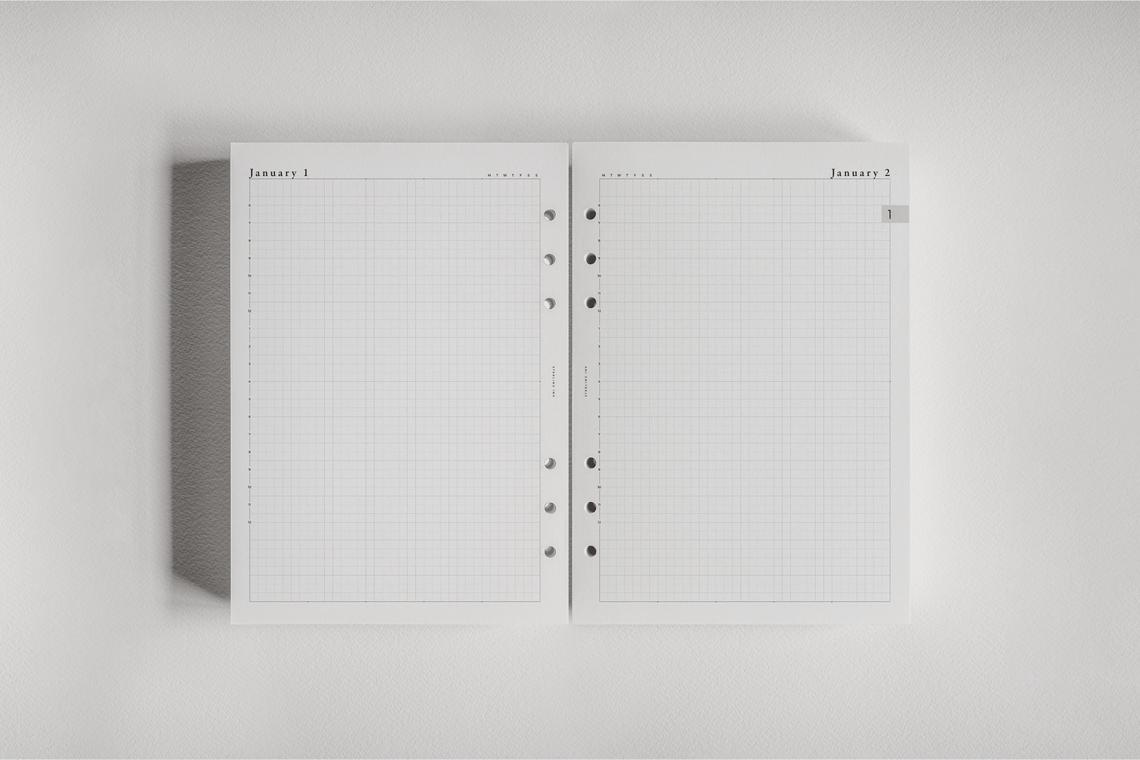 White, dated planner inserts displaying a daily grid layout and "January" headers, designed for organizing schedules and tasks in a ring-bound journal.