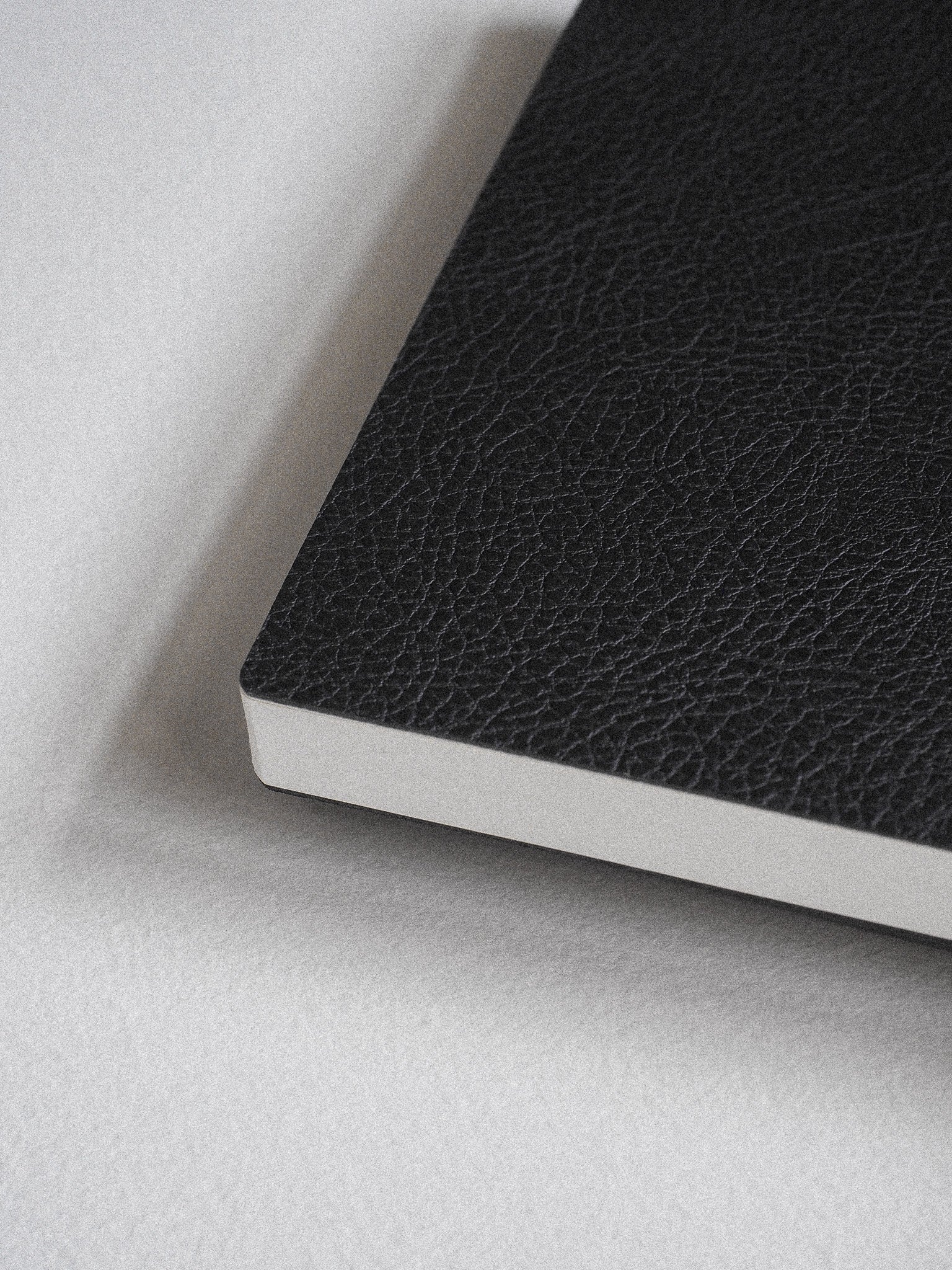Rich black A5 notebook featuring a textured, faux-leather cover and crisp white pages, ready for writing 272 lined pages of notes or journaling.