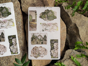 Vintage torn paper sticker sheets featuring delicate illustrations of classical ruins, detailed arches, and antique portraits for scrapbooking or journaling.