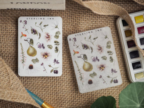 Delicate botanical sticker elements featuring hand-drawn illustrations of pears, varied blossoms, berries, and green leaves for creative journaling.