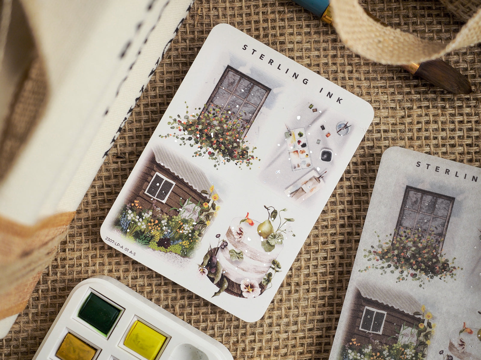 Detailed sticker sheets featuring whimsical illustrations of rustic cottages, overflowing floral arrangements, and vintage objects perfect for crafting.