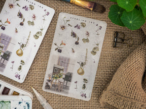 Botanical arrangement stickers titled 'Arrangement Stickers - July 2023', featuring delicate vintage florals, detailed herbs, and small architectural vignettes.