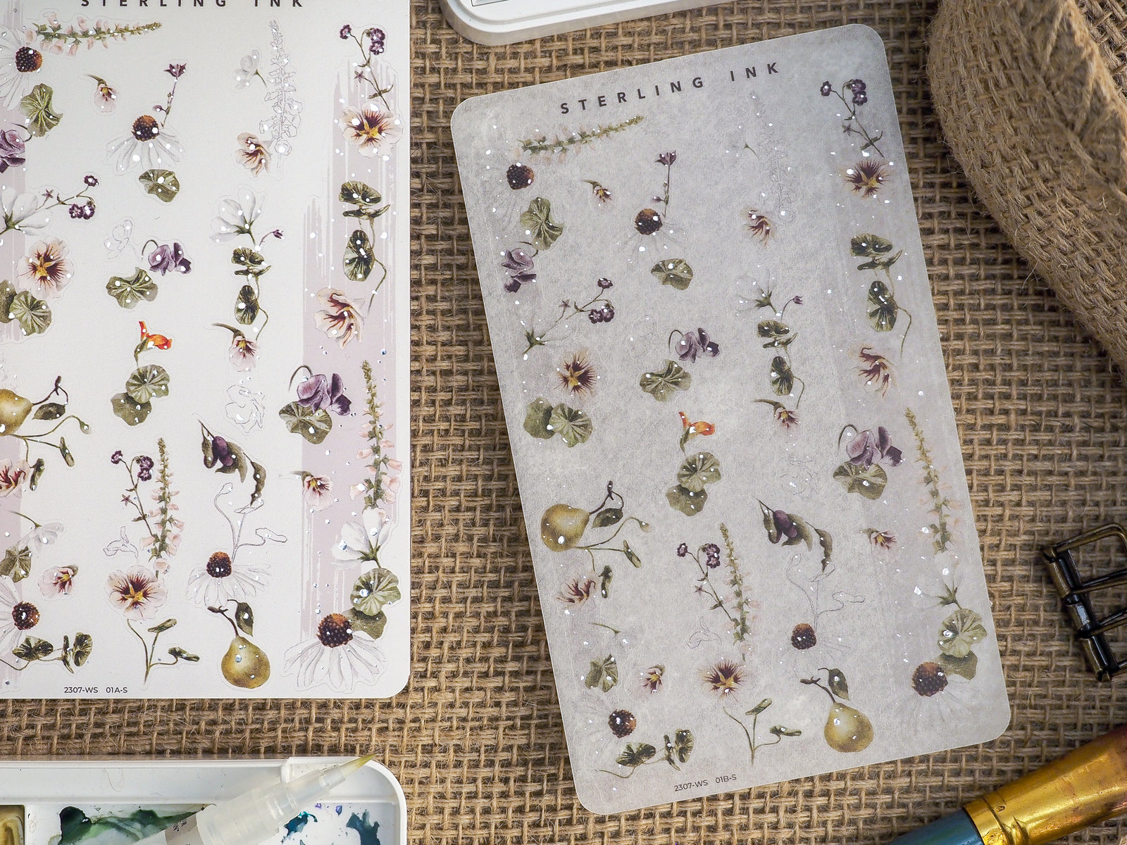 Delicate botanical washi strip stickers featuring detailed watercolor florals, berries, and green foliage on contrasting cream and dusty gray backgrounds.