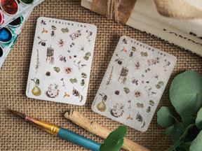 Mini icon stickers featuring botanical elements, miniature houses, and seasonal harvest illustrations on a pale cream background.