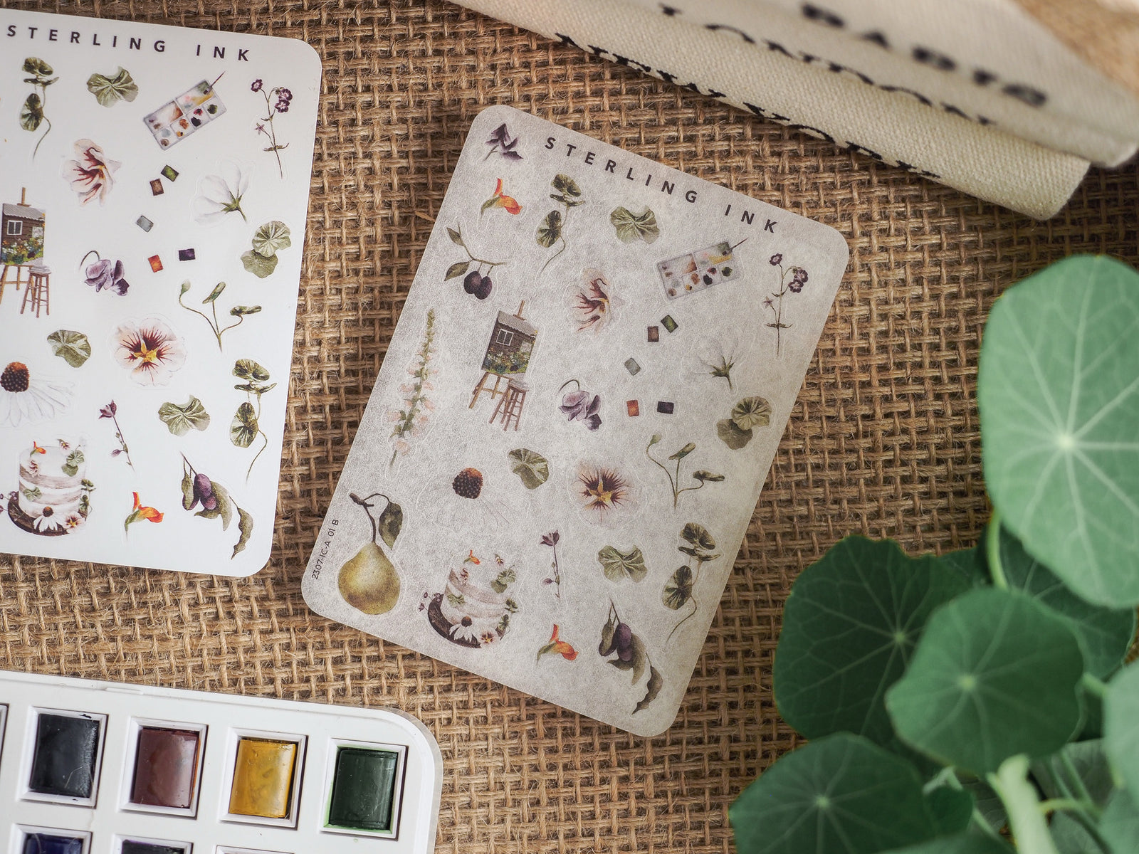 Sheet of delicate sticker icons featuring a variety of botanical elements, including flowers, herbs, small houses, and nature-themed illustrations.