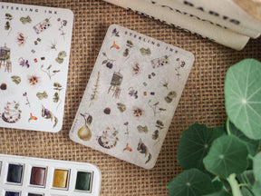 Sheet of delicate sticker icons featuring a variety of botanical elements, including flowers, herbs, small houses, and nature-themed illustrations.
