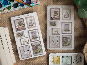 Decorative sheet of "Picture Frame Stickers - July 2023" featuring detailed, vintage-style illustrations of indoor scenes set within elegant decorative borders.