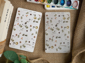 Vintage botanical sticker sheets featuring delicate, detailed illustrations of faded flowers, berries, and natural foliage in muted earth tones.