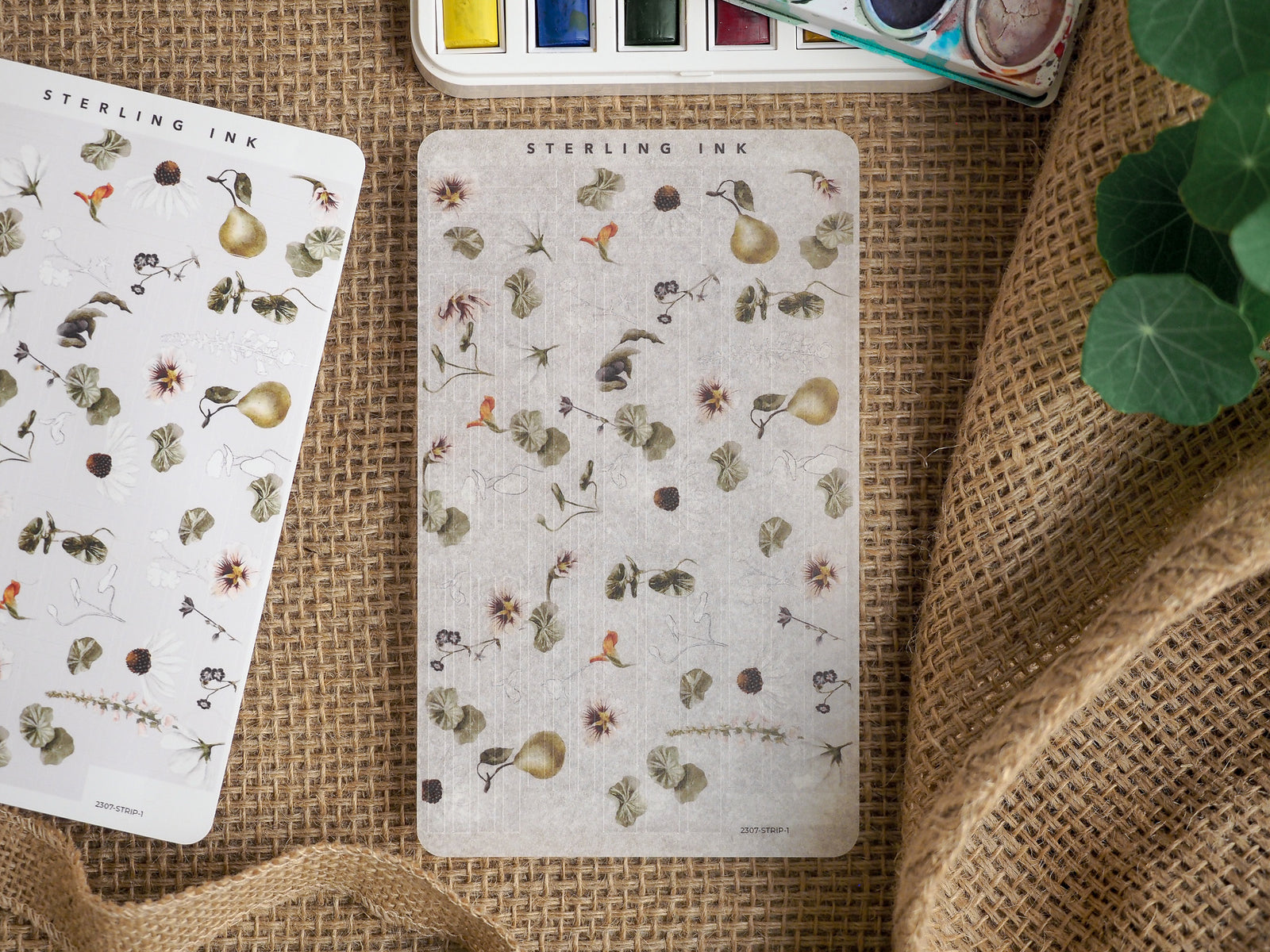 Delicate sticker sheet adorned with a cluster of tiny vintage botanical illustrations, leaves, and light-colored natural accents for journaling.