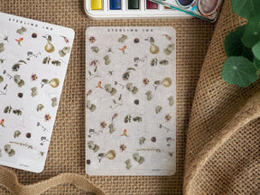 Delicate sticker sheet adorned with a cluster of tiny vintage botanical illustrations, leaves, and light-colored natural accents for journaling.
