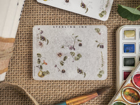 Botanical sticker sheet featuring watercolor illustrations of scattered berries, small white blossoms, and delicate greenery, ideal for crafting and journaling decor.