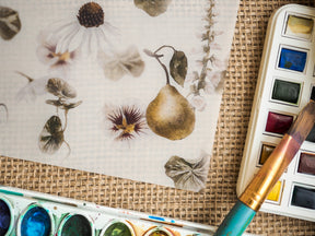 Vintage stationery adorned with soft watercolor botanical illustrations of pomegranates, daisies, and various foliage elements.
