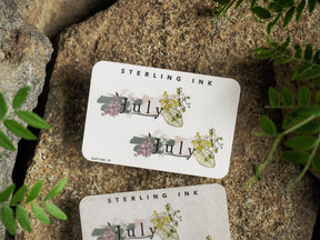 Charming "July" month sticker decorated with delicate watercolor bouquets of pink, green, and yellow floral accents for planners.