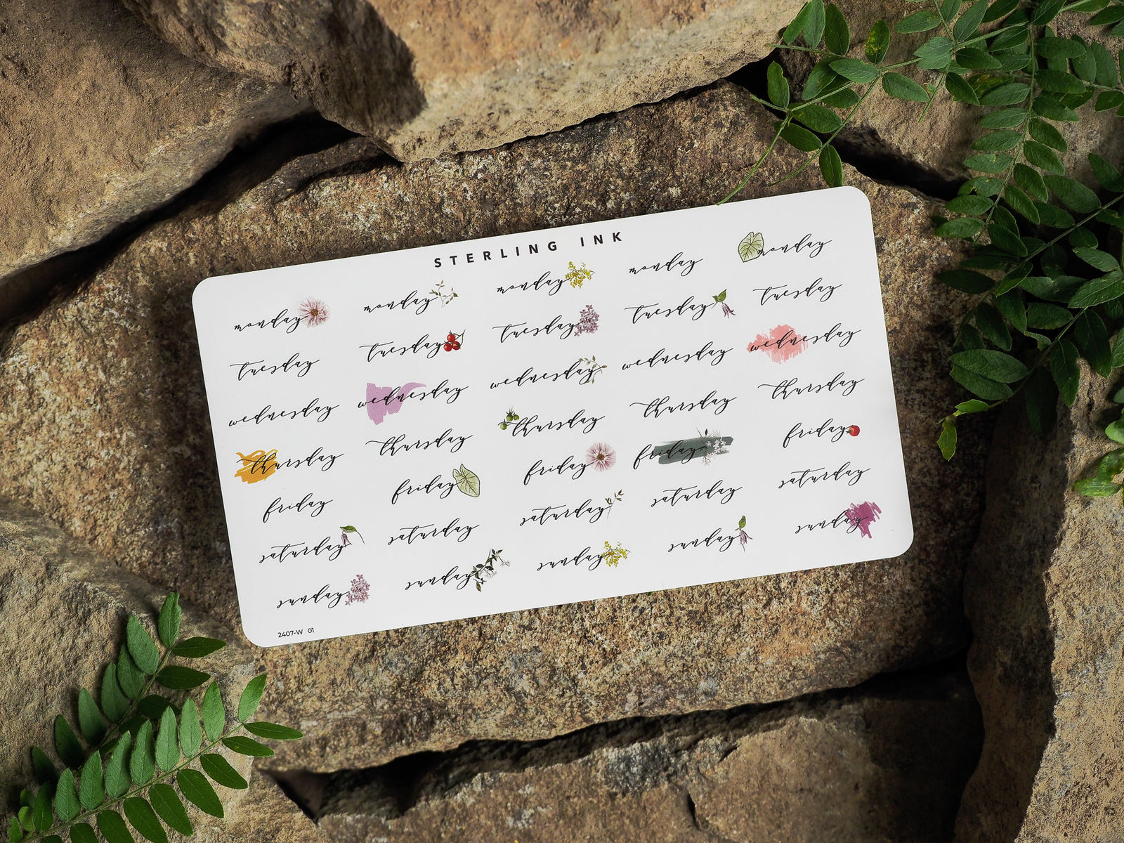 A printable set of Weekday Stickers for July 2024, featuring labeled slots for Monday through Sunday and delicate, earthy floral corner accents.