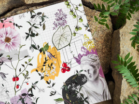 Botanical planner sheet featuring pink peonies, green foliage, clusters of purple blooms, red berries, and a vintage portrait for Vellum - July 2024.