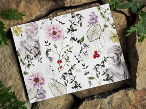Botanical printable featuring soft floral bouquets, lush green leaves, scattered berries, and subtle charcoal illustrations set against a delicate grid pattern.