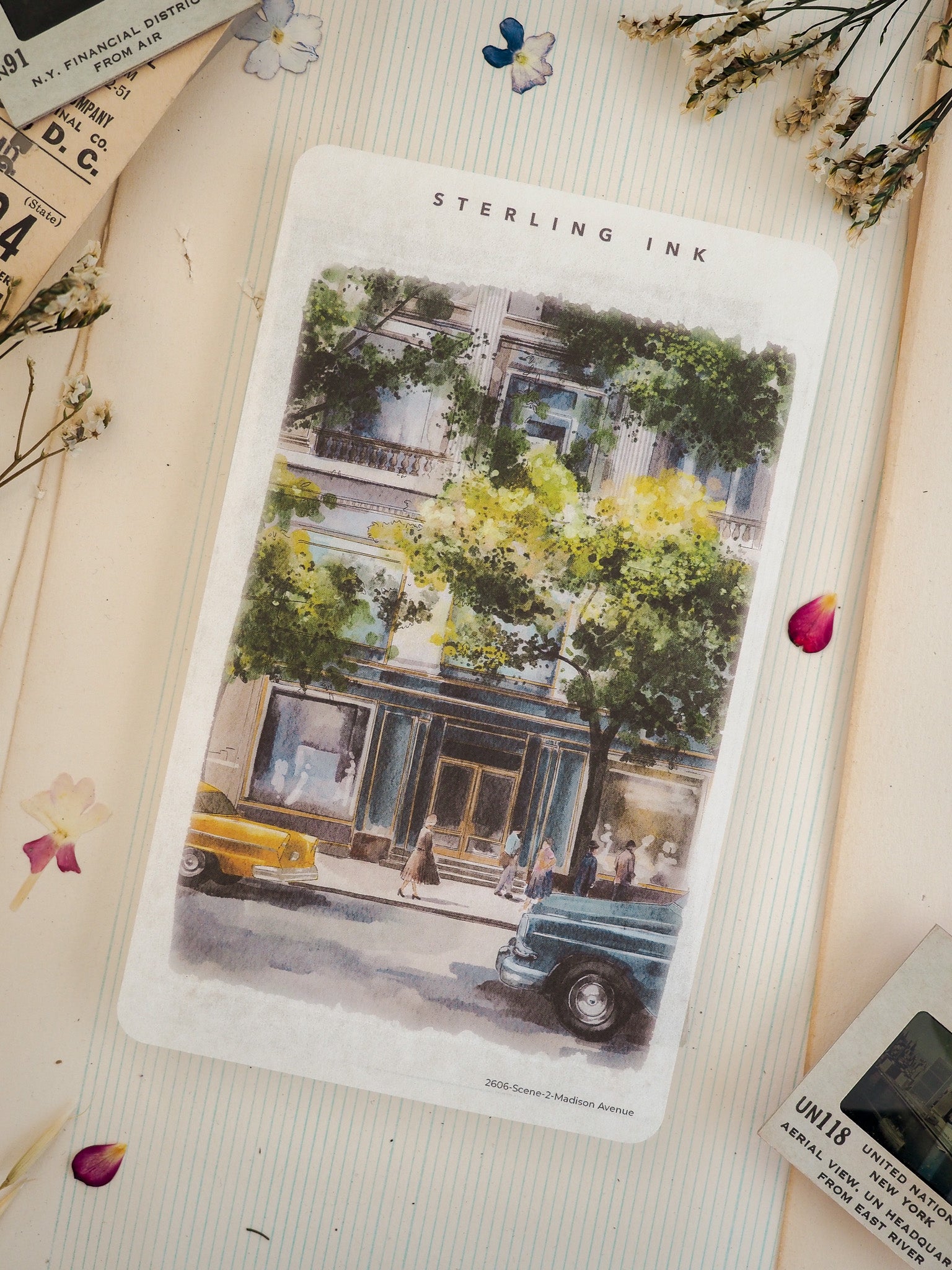 Watercolor illustration of 2606 Madison Avenue featuring a multi-story building facade adorned with vibrant green and yellow foliage, parked vintage cars, and pedestrians.