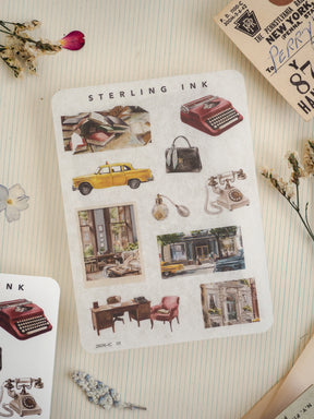 Vintage sticker sheet labeled "STERLING INK," featuring a collection of detailed historical illustrations including classic typewriters, yellow vintage cars, and charming old-fashioned storefronts.