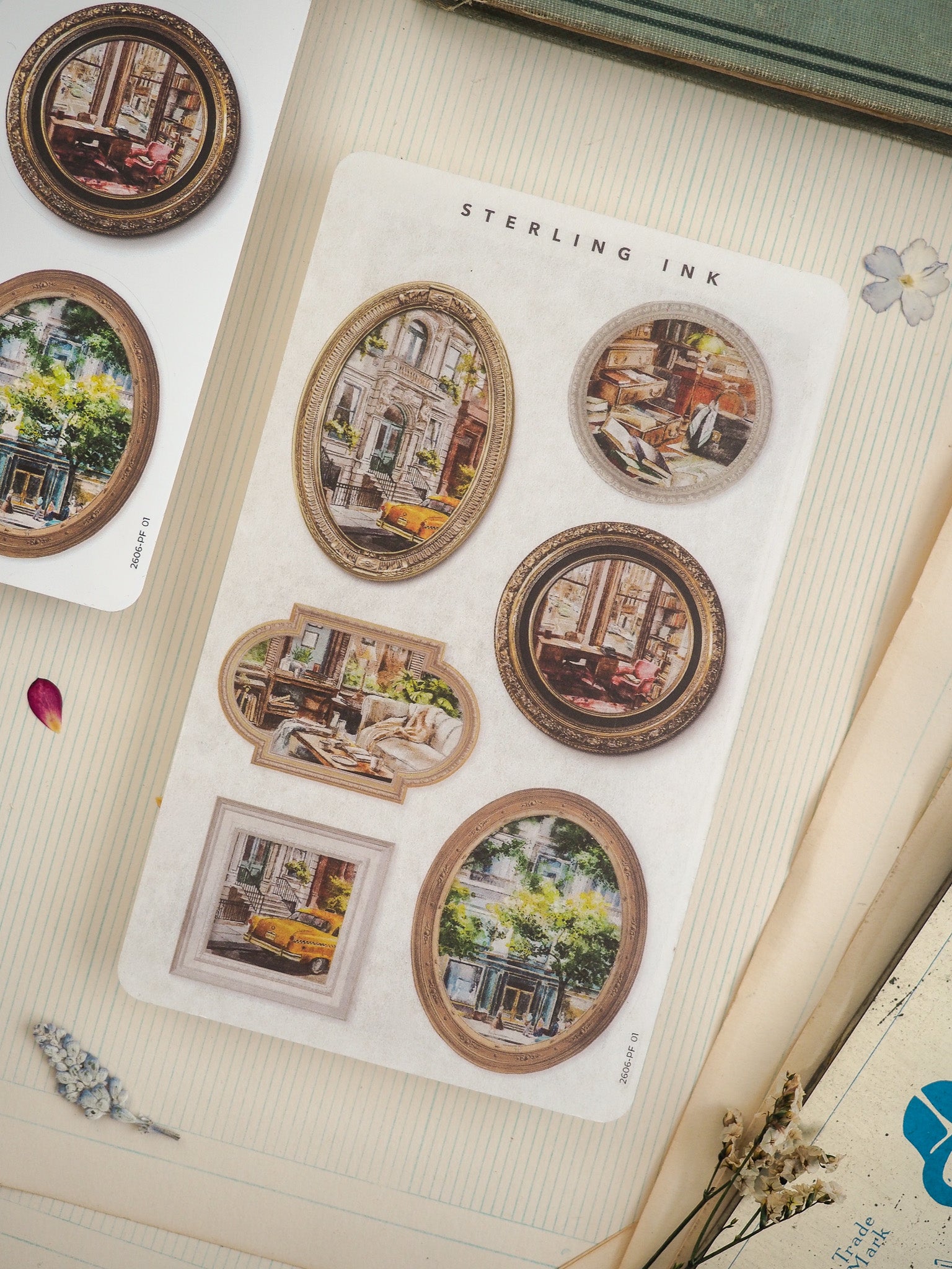 Vintage "Sterling Ink" sticker sheet with ornate frames, featuring themed circular and oval designs of aged urban scenes and architectural details.
