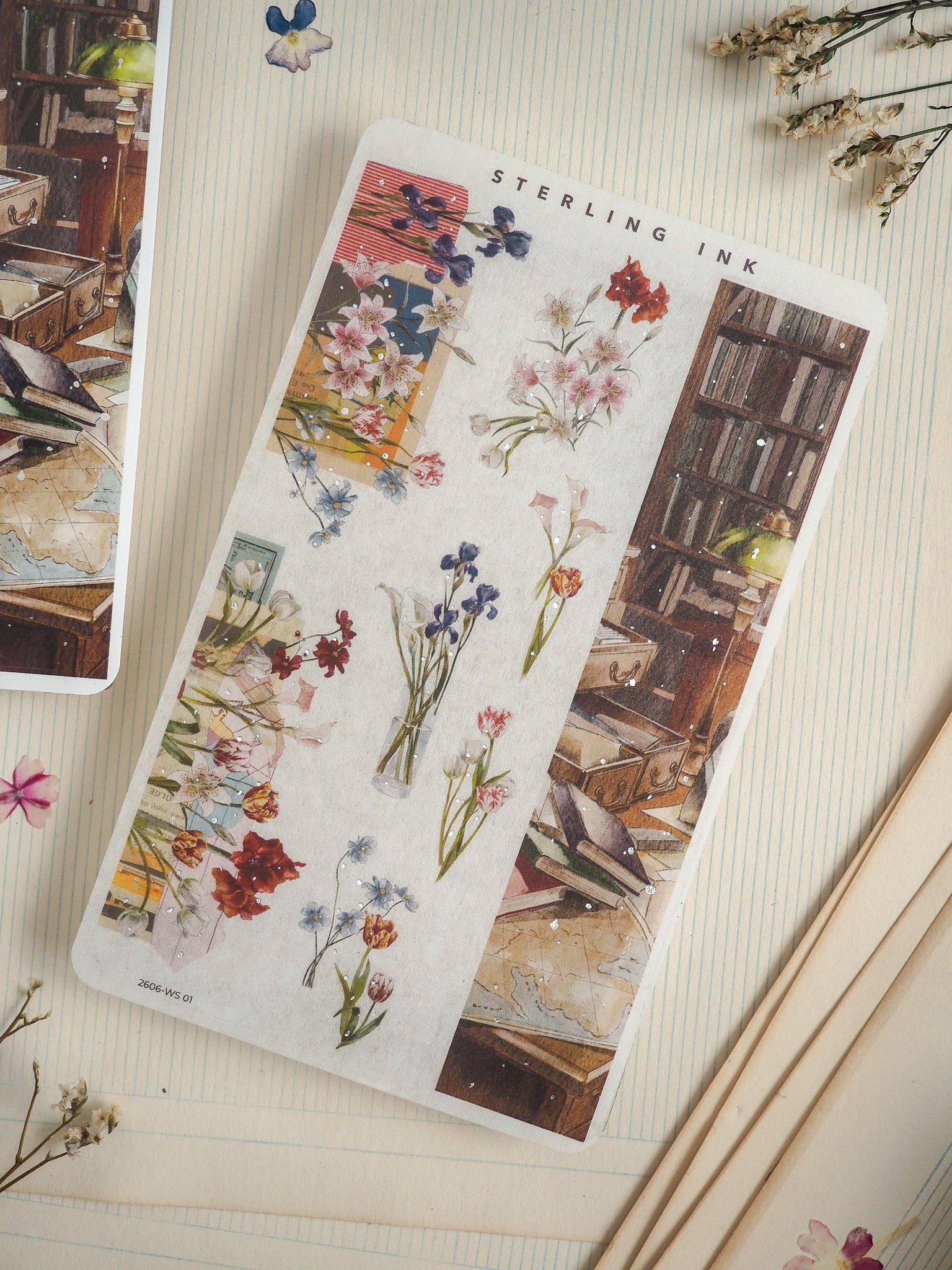 Vintage botanical sticker labeled "Sterling Ink," featuring delicate watercolor bouquets of pastel flowers paired with an antique illustration of a cluttered wooden bookshelf.
