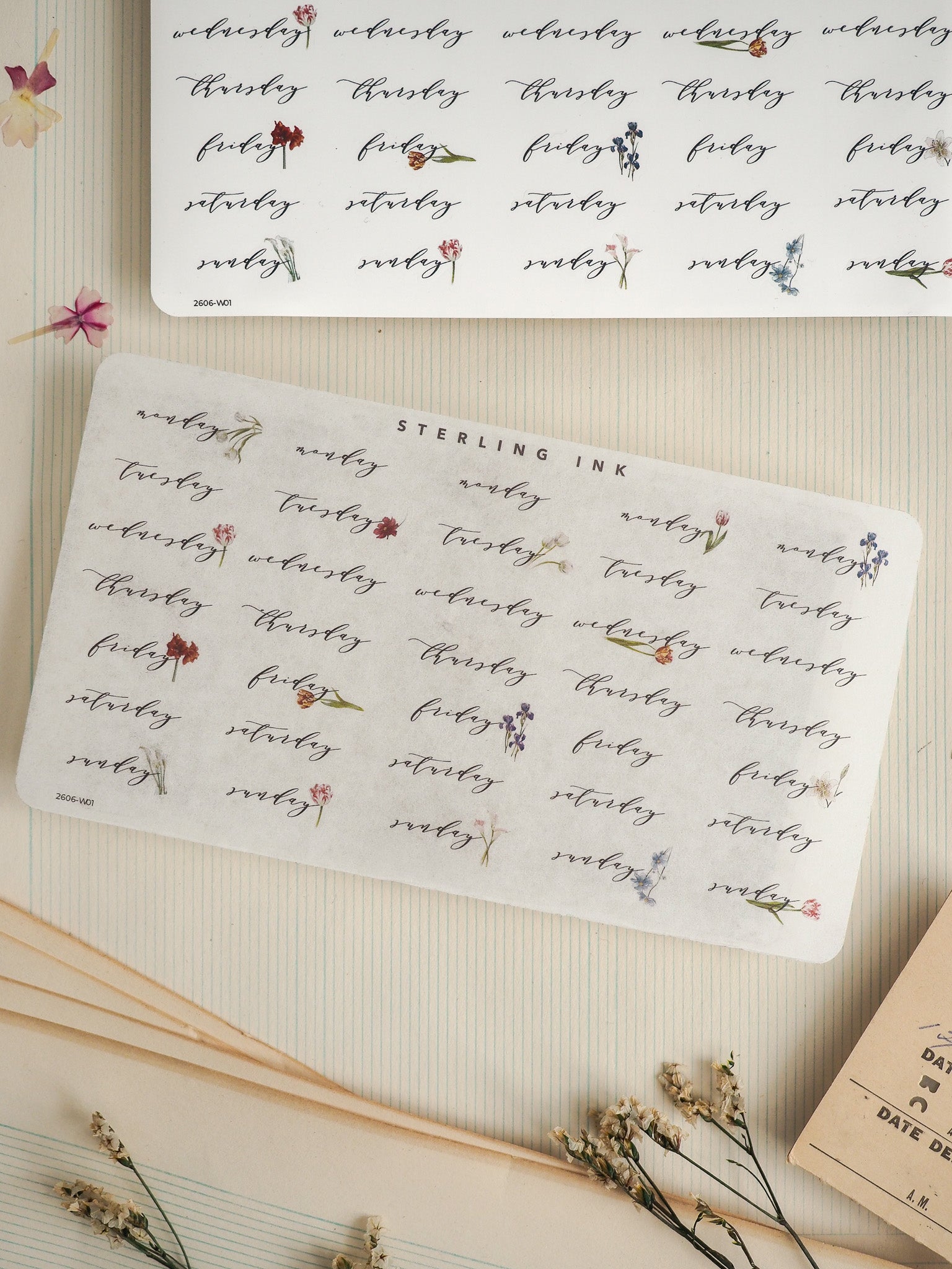 Decorative patterned sticker sheet featuring the days of the week and "Sterling Ink," printed in black ink with small complementary floral motifs for journaling.