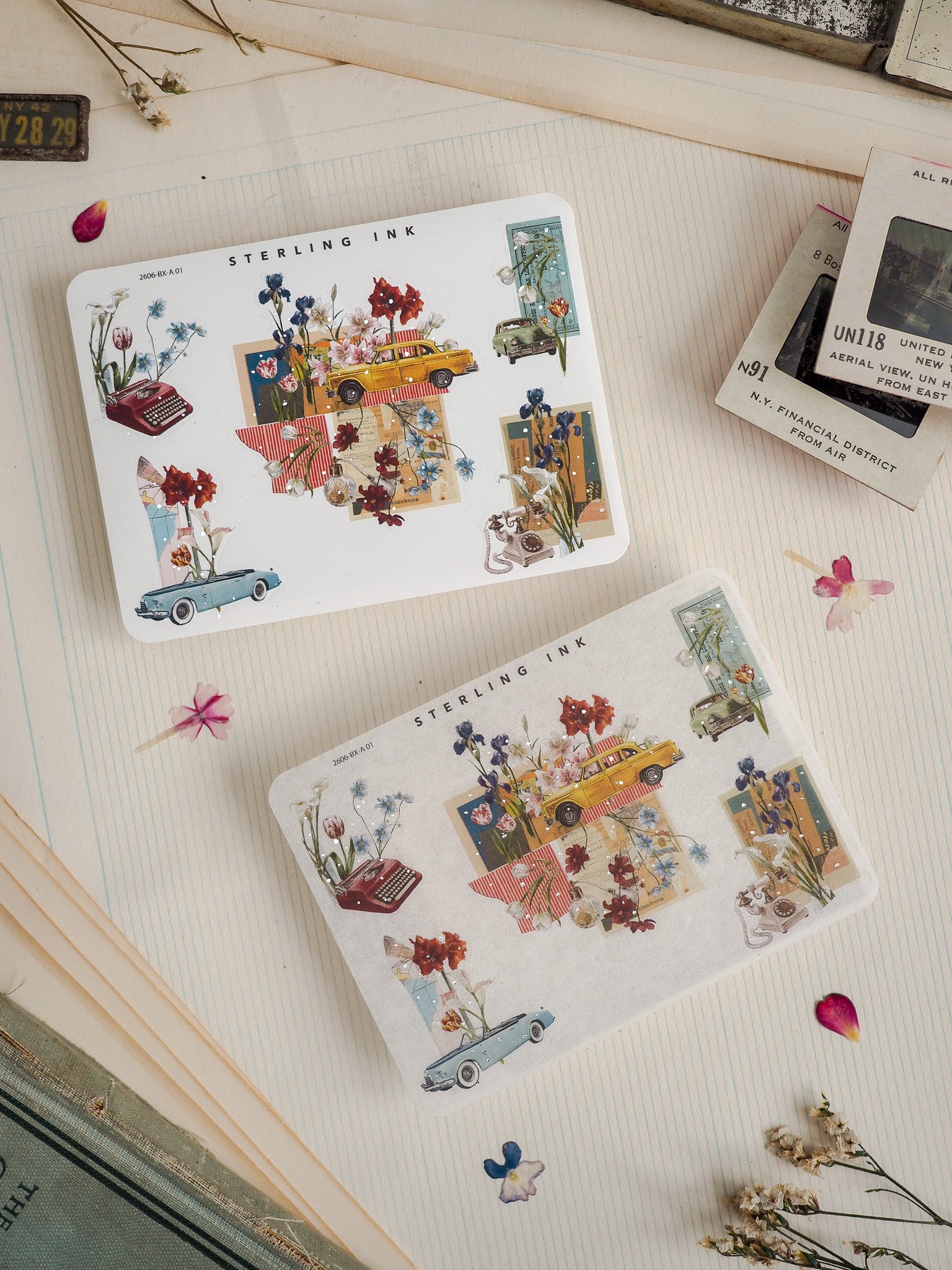 Charming sticker sheets displaying a richly detailed vintage street scene, featuring miniature cars, overflowing flowers, and quaint buildings in a nostalgic, illustrated pattern.
