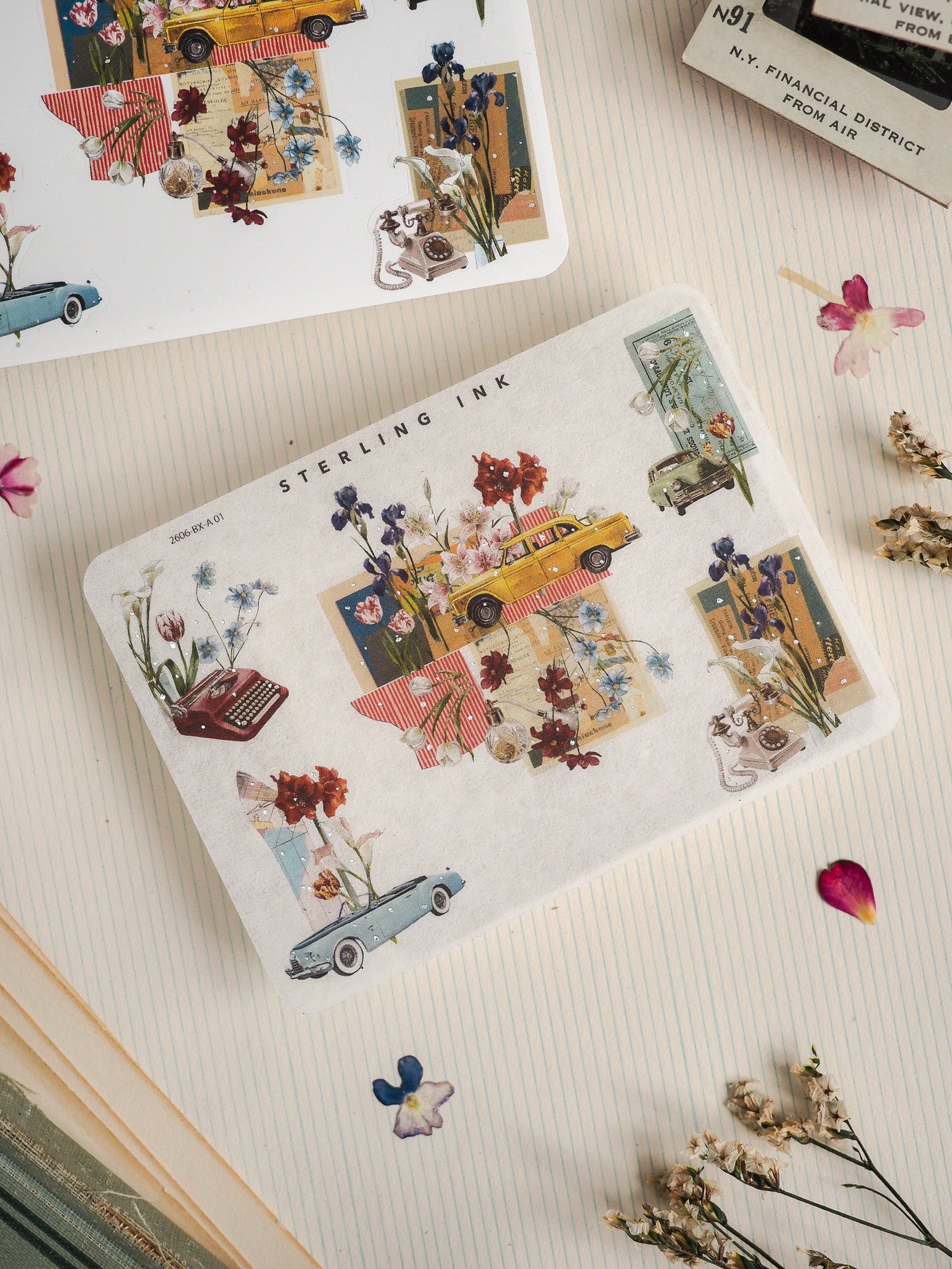 Illustrative "Sterling Ink" sticker sheet featuring whimsical vintage cars, blooming flowers, and rustic urban vignettes in a muted, nostalgic color palette.