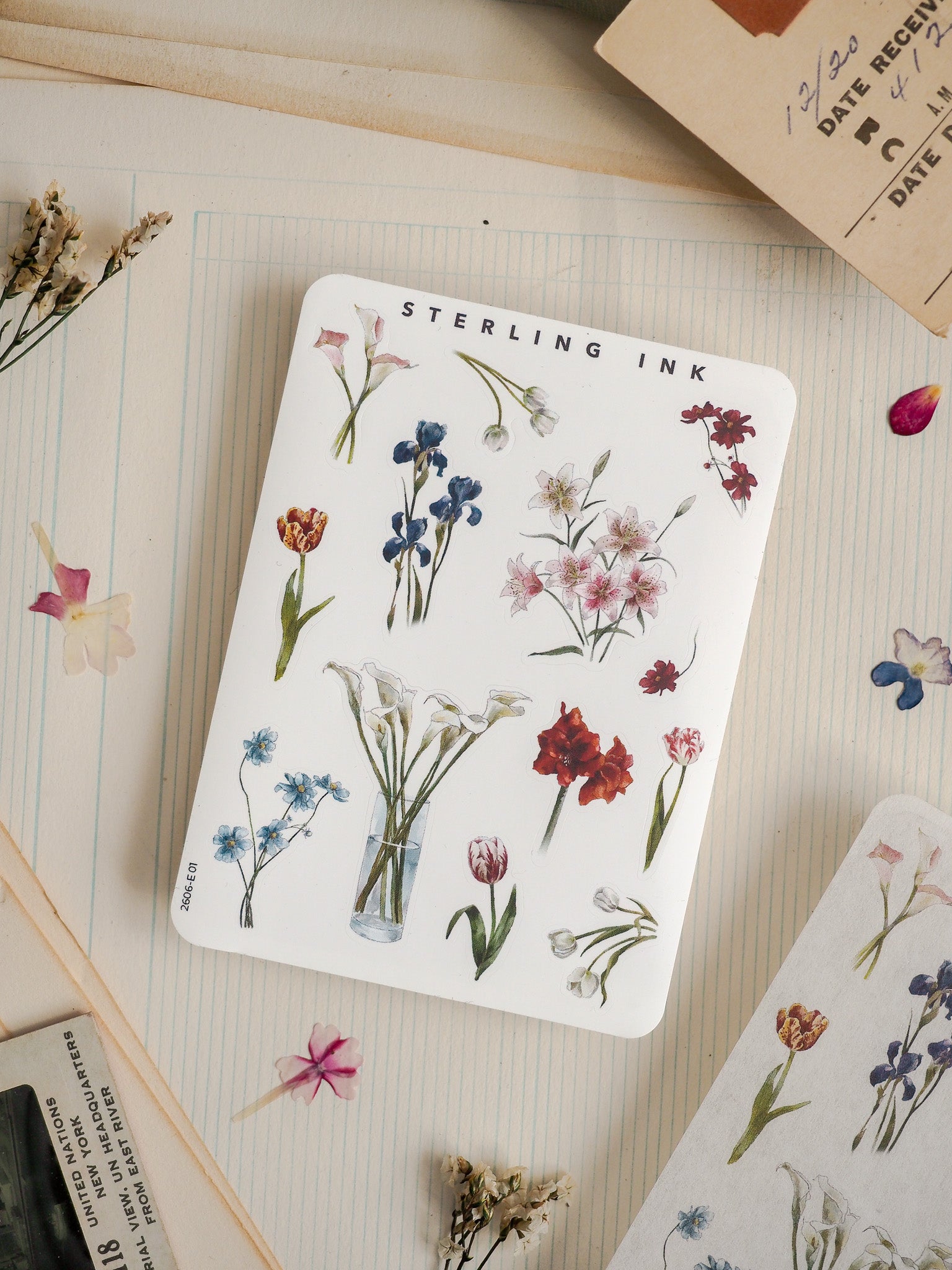 Watercolor botanical sticker featuring "Sterling Ink" and detailed clusters of blue, pink, and red wildflowers, perfect for crafting.