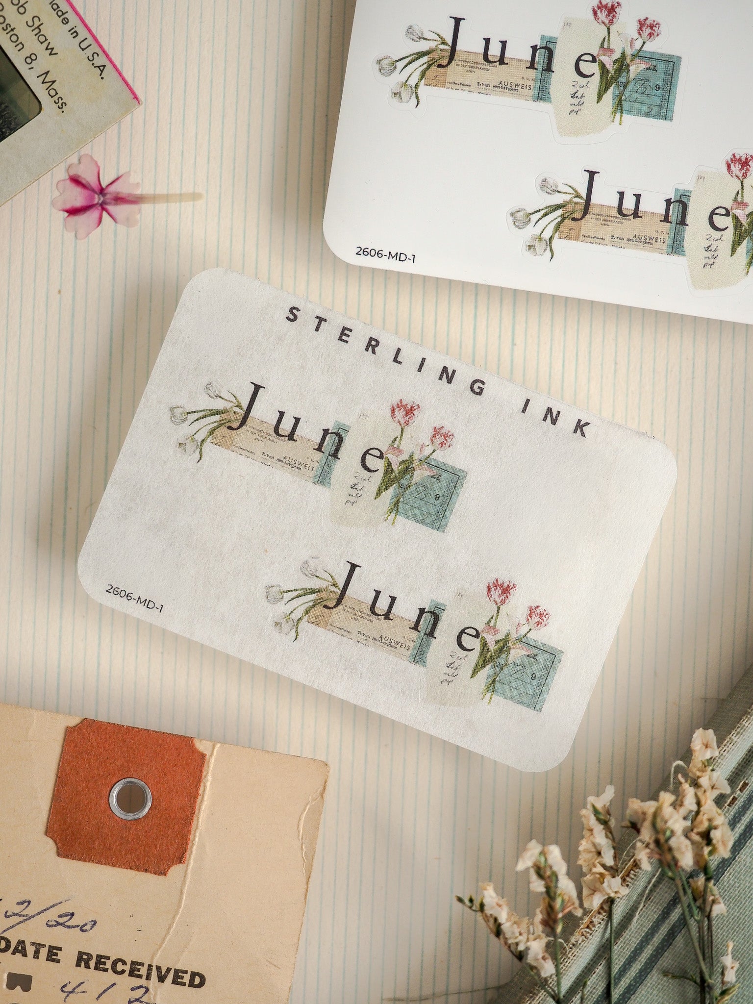 Vintage stationery featuring a "STERLING INK" design with delicate floral stamps and "June" postage motifs, perfect for journaling or scrapbooking.