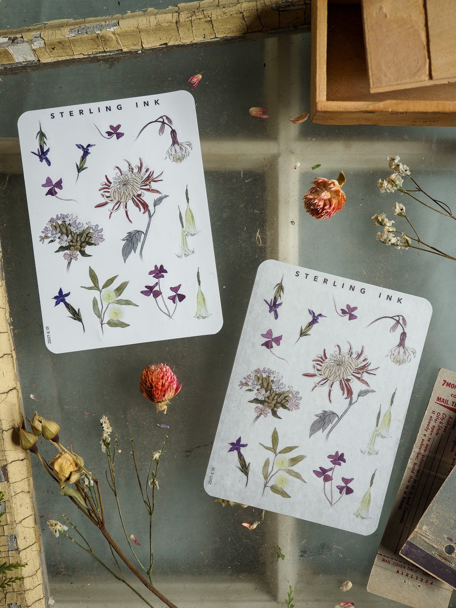 Watercolor botanical stickers featuring elements of wildflowers, deep purples, and lush greens, suitable for journaling and crafting.
