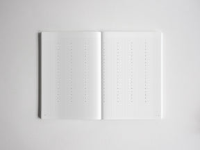Open journal notebook open to two pages of white graph paper, ideal for academic notes, bullet journaling, or structured planning.