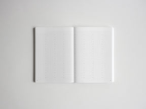 Open notebook displaying two pages of precise dotted grid paper, ideal for bullet journaling, planning, and creative note-taking.