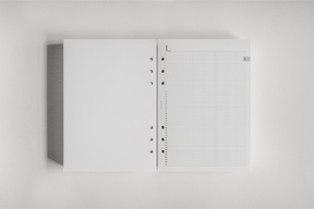 White spiral-bound daily planner insert featuring a smooth blank page adjacent to a detailed, structured graph grid layout for organized 2026 tracking.