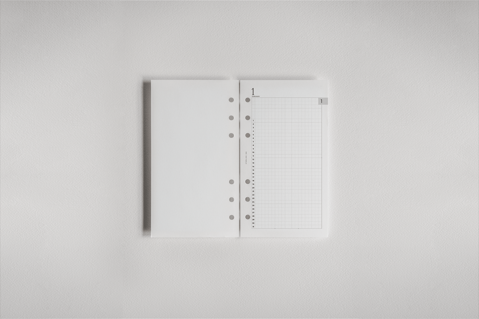 Structured white daily planner inserts featuring a perforated grid layout, ideal for organizing 2026 appointments and detailed schedules.
