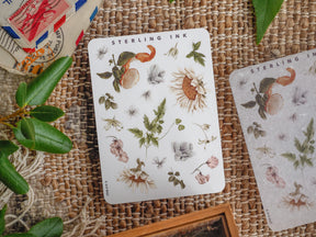 Cream-toned sheet featuring beautiful botanical elements, including detailed watercolor illustrations of sunflowers, various flowers, and lush green foliage.