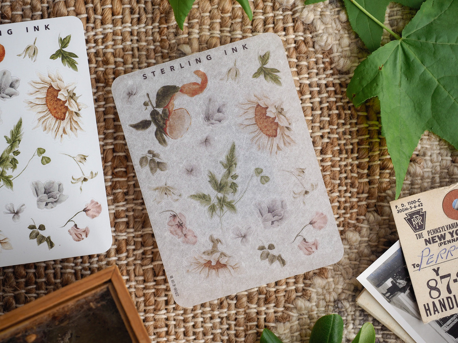 Botanical sticker sheet featuring delicate, muted illustrations of sunflowers, dried grasses, and various foliage elements titled 'Sterling Ink'.