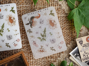 Botanical sticker sheet featuring delicate, muted illustrations of sunflowers, dried grasses, and various foliage elements titled 'Sterling Ink'.