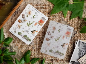 Botanical icon sticker sheet featuring vintage illustrations of jars, insects, and greenery with decorative silver foil accents, themed for August 2023.