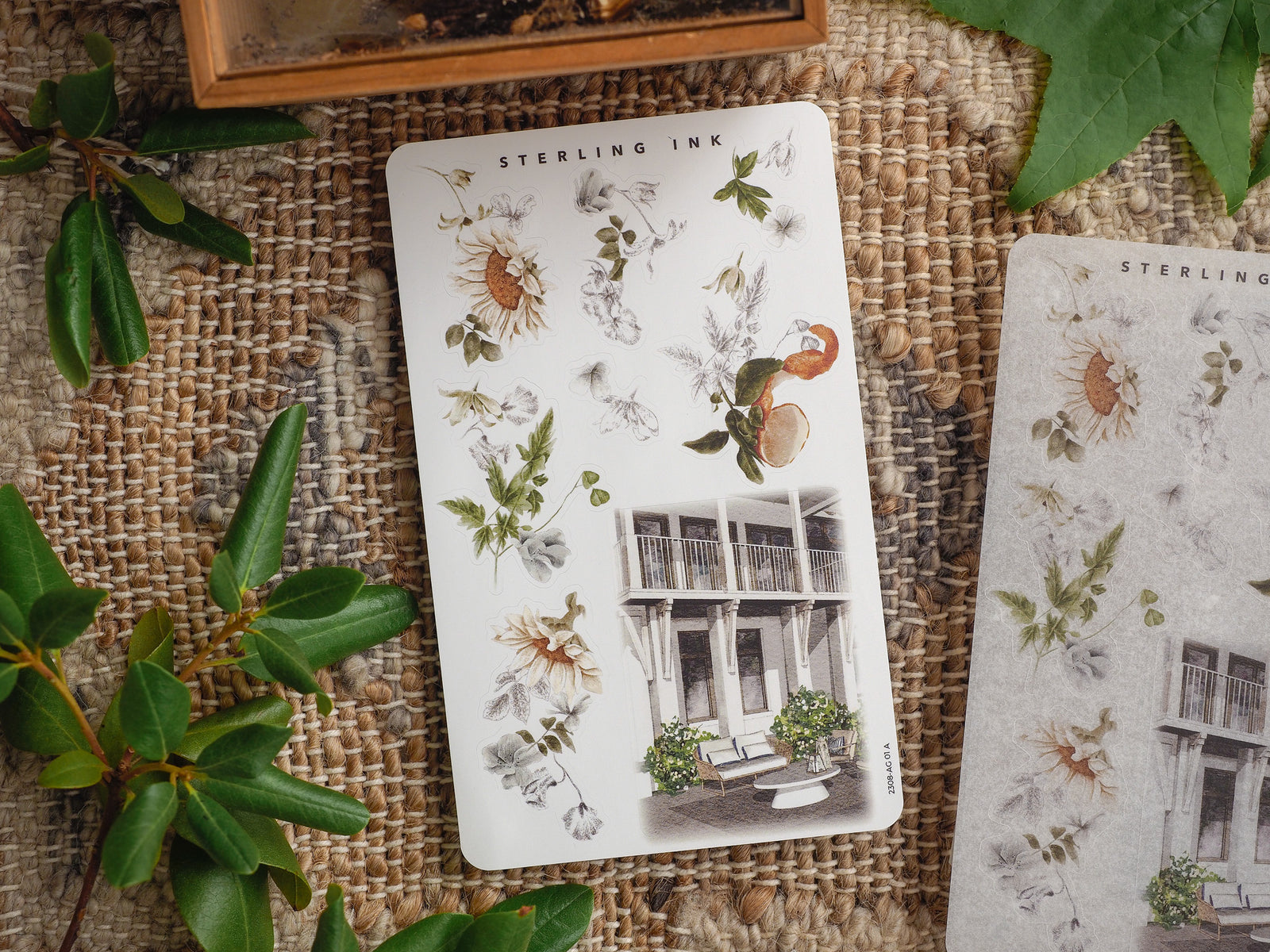 Sterling Ink sticker sheet featuring a seasonal arrangement of delicate dried wildflowers, leaves, and charming vintage European architectural engravings.