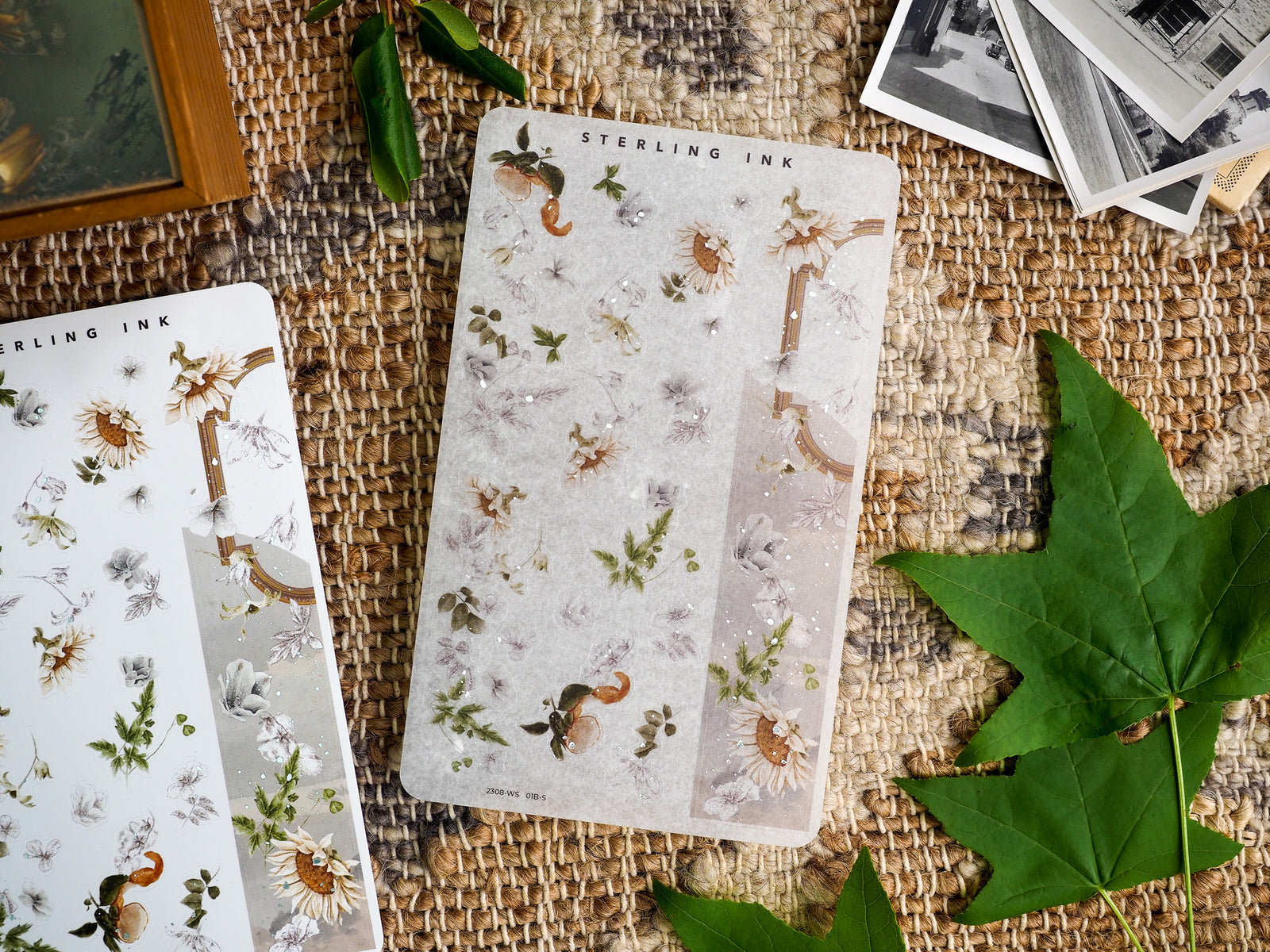 Rustic botanical washi stickers featuring faded sunflowers, delicate green foliage, and elegant floral sprigs scattered across cream paper.