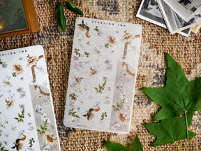 Rustic botanical washi stickers featuring faded sunflowers, delicate green foliage, and elegant floral sprigs scattered across cream paper.