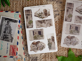 Vintage torn paper stickers featuring distressed architectural sketches and building facades in warm, aged sepia tones.