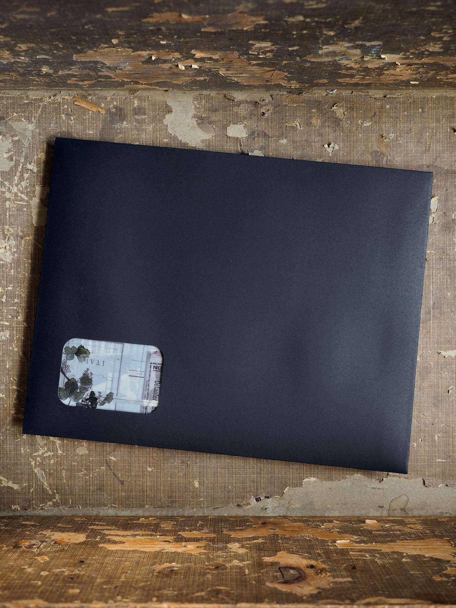 Matte black planner journal featuring a corner sticker with delicate black and white botanical illustrations, perfect for August 2025 organization.