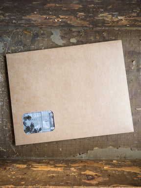 Kraft-colored cardstock stationery featuring a small, rustic sticker detail, suitable for organizing the August 2025 subscription kits.