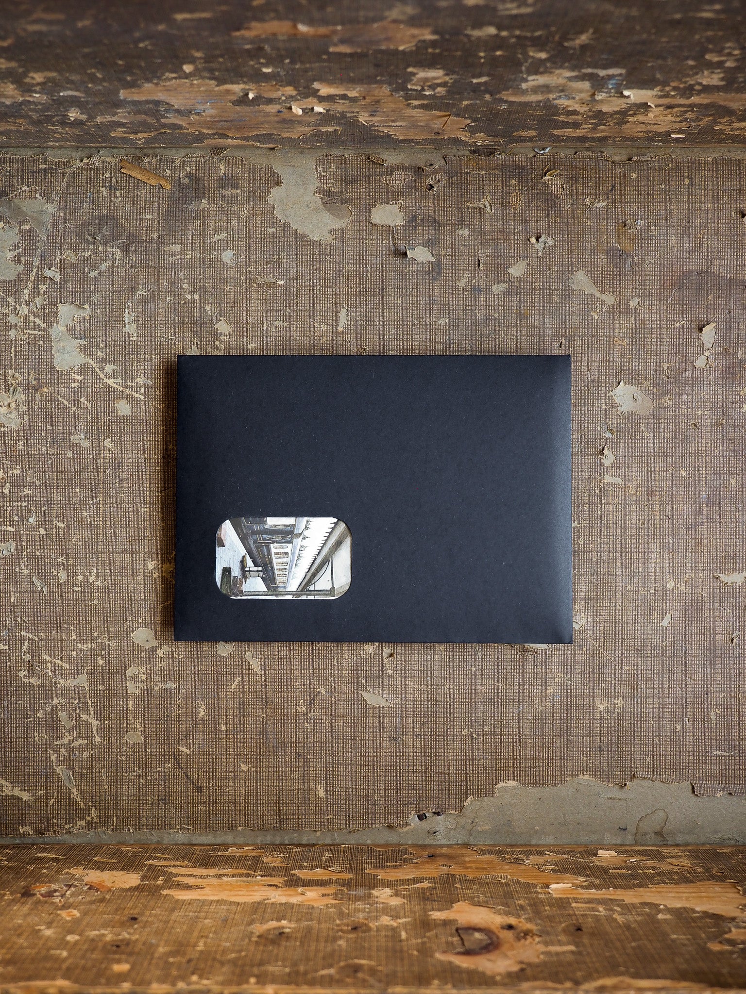 Minimalist dark gray subscription kit packaging featuring a subtle vertical graphic detail on the front cover.