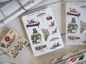 Miniature elements icon sticker sheet featuring detailed black ink illustrations of vintage architecture, outdoor awnings, cozy furniture, and charming domestic scenes.